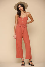 Load image into Gallery viewer, Brick color semi cropped jumpsuit with button &amp; waist ribbon detail and adjustable straps. Cotton blend.
