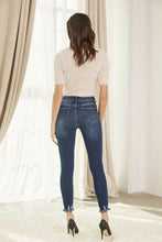 Load image into Gallery viewer, Brushed dark wash high rise ankle skinny with bottom fray hem detail. Cotton blend.
