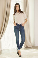 Load image into Gallery viewer, Brushed dark wash high rise ankle skinny with bottom fray hem detail. Cotton blend.
