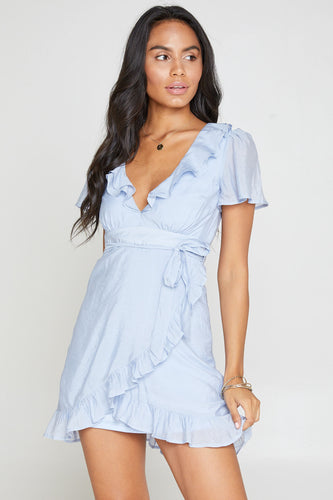 Sky blue flirty wrap dress with ruffle and tie-waist details.