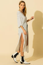 Load image into Gallery viewer, White and black polka dot pattern kimono with tie waist and side slit details.
