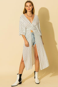 White and black polka dot pattern kimono with tie waist and side slit details.