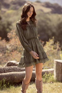 Olive colored tiered ruffle dress with tie details. Dress is lined.
