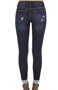 Dark wash low rise ankle skinny with some subtle distressing. Cotton blend.