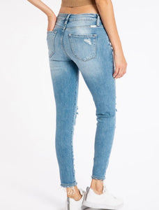 Light wash mid rise skinny jeans with some distressing