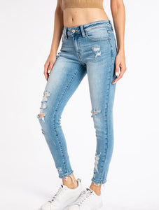 Light wash mid rise skinny jeans with some distressing