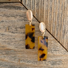 Load image into Gallery viewer, Acrylic dangle earrings with gold oval post detail.  Earring measures approx 1.5&quot;.  Metal Content: Blended Metal. Color: Tortoise
