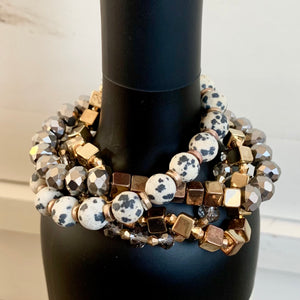 Glass and stone with mixed metal stretch beaded bracelets.  Set of 4 bracelets in each color combo.  Metal Content: Blended Metal. Color: Dalmatian Jasper