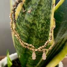 Load image into Gallery viewer, Gold dipped beaded bracelet with CZ hamsa detail.
